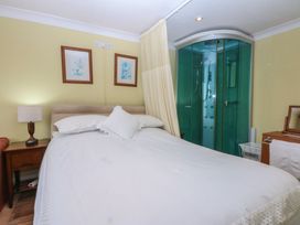 A bedroom with a bed and a shower at Maesawel Studio Llanfair