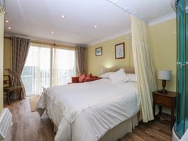 A bedroom with bed and seating area at Maesawel Studio in Llanfair