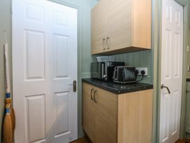 A kitchen with a cupboard and appliances at Maesawel Studio in Llanfair