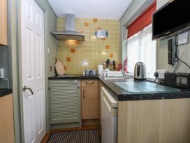 A kitchen with appliances and utensils at Maesawel Studio in Llanfair