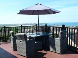 An outdoor patio with a table and chairs at Maesawel Studio in Llanfair