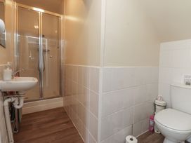 A bathroom with a shower, sink, and toilet at The Farmhouse in Brynsiencyn near Newborough