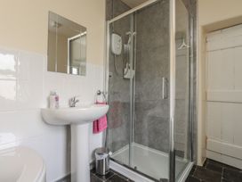 A bathroom with a sink and shower at The Farmhouse in Brynsiencyn near Newborough