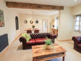 A living room with a sofa and table at Rose Cottage in Crosby on Eden near Carlisle