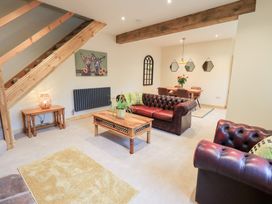 A living room with a sofa and table at Rose Cottage in Crosby on Eden near Carlisle