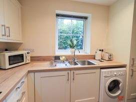 A kitchen with a sink and washing machine at Rose Cottage in Crosby on Eden near Carlisle