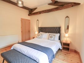 A bedroom with a bed and bedside tables at Rose Cottage in Crosby on Eden near Carlisle