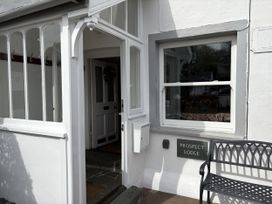 An entrance with a door and a bench at Prospect Lodge in Portinscale