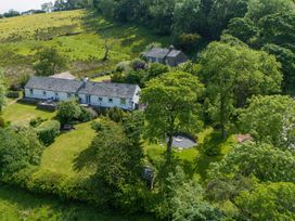 An outdoor area with a house and garden at Mell View Cottage Ullswater