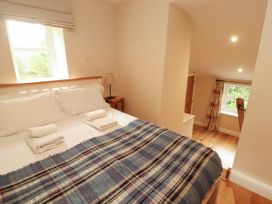 A bedroom with a bed and a nightstand at Mell View Cottage in Ullswater