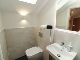 A bathroom with a toilet and hand basin at Mell View Cottage in Ullswater