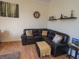 A living room with a sofa and shelves at St Johns View in Keswick