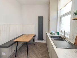A kitchen with a dining table and sink at St Johns View in Keswick
