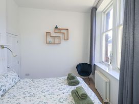 A bedroom with a bed and decorative shelves at St Johns View in Keswick