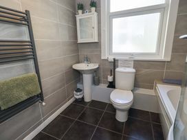A bathroom with a sink, toilet, and towel rack at St Johns View in Keswick
