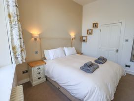 A bedroom with a bed and bedside table at St Johns View in Keswick