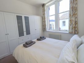 A bedroom with a bed and wardrobe at St Johns View in Keswick