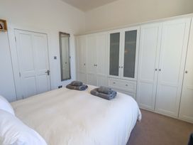 A bedroom with a bed and wardrobe at St Johns View in Keswick