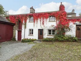 A house with ivy on the walls at Mill Cottage Garnett Bridge
