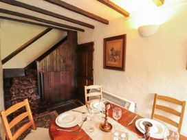 A dining room with a table set for a meal at Mill Cottage in Garnett Bridge