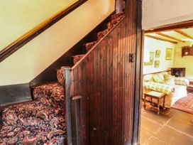A staircase and living room area at Mill Cottage in Garnett Bridge
