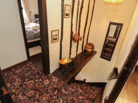 A staircase with wooden features and decor at Mill Cottage Garnett Bridge
