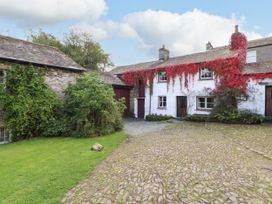 An outdoor view of a cottage with ivy at Mill Cottage in Garnett Bridge