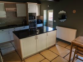 A kitchen with a sink and stove at Carwinley Mill House Cottage, Longtown