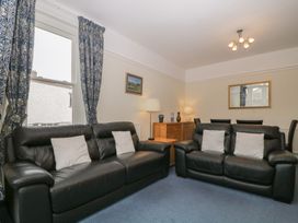 A living room with sofas and a lamp at Amba in Keswick