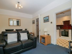 A living room with a sofa and a kitchen in the background at Amba, Keswick