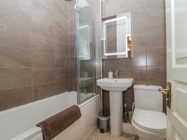 A bathroom with a bathtub and shower at Amba in Keswick