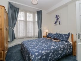 A bedroom with a bed and wardrobe at Amba in Keswick