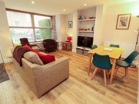 A living room with a sofa and television at Archers in Keswick