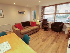 A living room with a sofa and armchair at Archers in Keswick