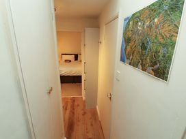 A hallway leading to a bedroom with a map on the wall at Archers in Keswick