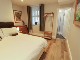 A bedroom with a bed and a wardrobe at Archers in Keswick