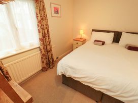 A bedroom with a bed and lamp at Archers in Keswick