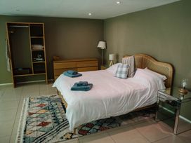 A bedroom with a bed and wardrobe at The Heronry, Longtown