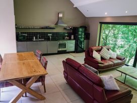 A kitchen and living room with a dining area at The Heronry in Longtown