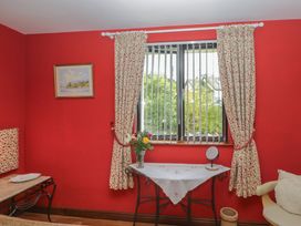 A sitting room with a window and a table at Stonegarth Cottage in Grasmere