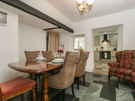 A dining room with a table and chairs at Fountain Cottage in Keswick