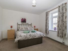 A bedroom with a bed and bedside tables at Fountain Cottage in Keswick