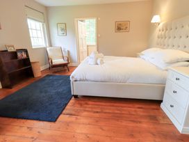 A bedroom with a bed and nightstand at Little Ellers in Portinscale near Keswick