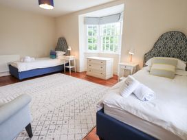 A bedroom with two beds and a window at Little Ellers in Portinscale near Keswick