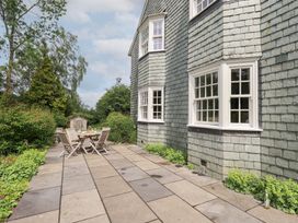 An outdoor patio area with a table and chairs at Little Ellers in Portinscale near Keswick