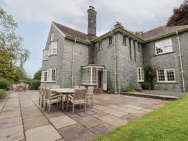 An outdoor patio with a table and chairs at Little Ellers in Portinscale near Keswick