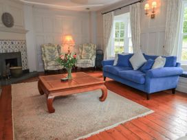 A living room with armchairs, a sofa, and a coffee table at Little Ellers Portinscale near Keswick