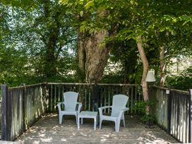 An outdoor seating area with two chairs and a table at The Snug in Longtown