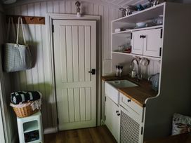 A kitchen with a sink and storage at The Snug in Longtown