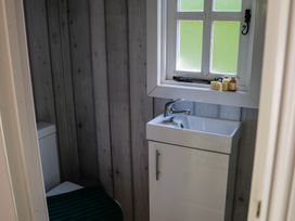 A bathroom with a toilet and sink at The Snug in Longtown